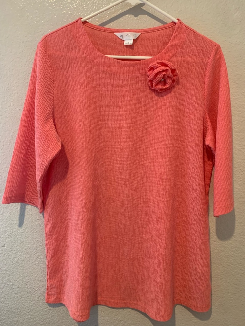 Coral Knit Three-Quarter Sleeve Top with Floral Accent